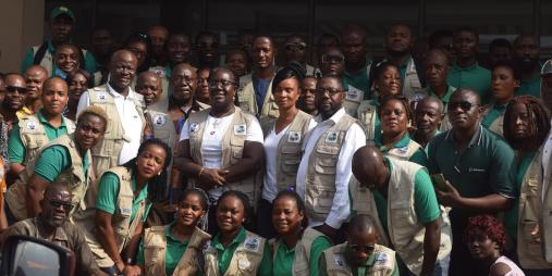 Minister Mawine G. Diggs with inspectors of the Minister of Commerce.